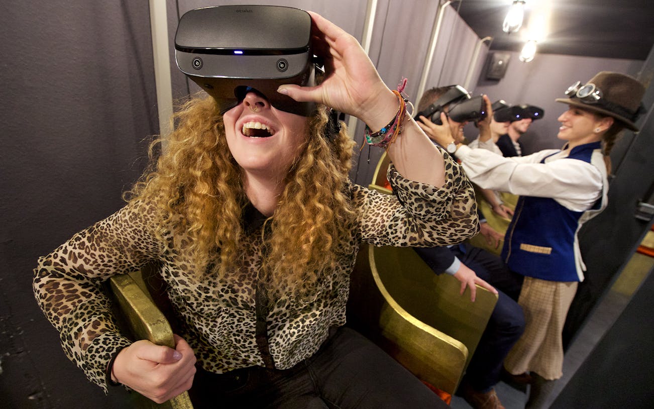 Visitors enjoying VR headsets at TimeRide Munich experience.