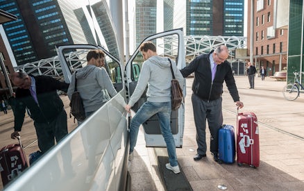 Passengers entering a van with luggage for private airport transfer at KLIA/KLIA2.