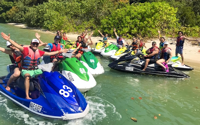 Group enjoying jet ski tour near lush island in Langkawi.