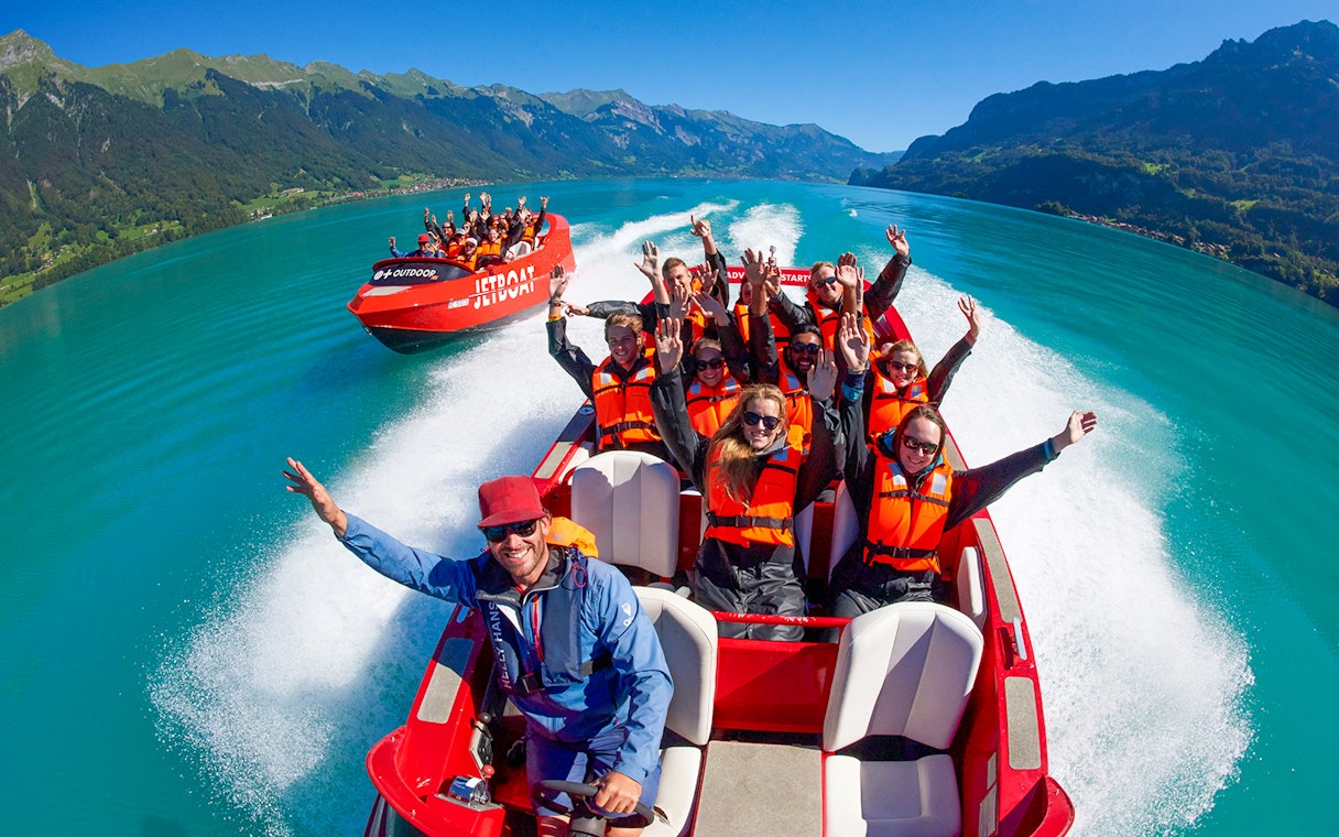 Jetboat ride on Lake Brienz with passengers in life jackets enjoying the scenic view.