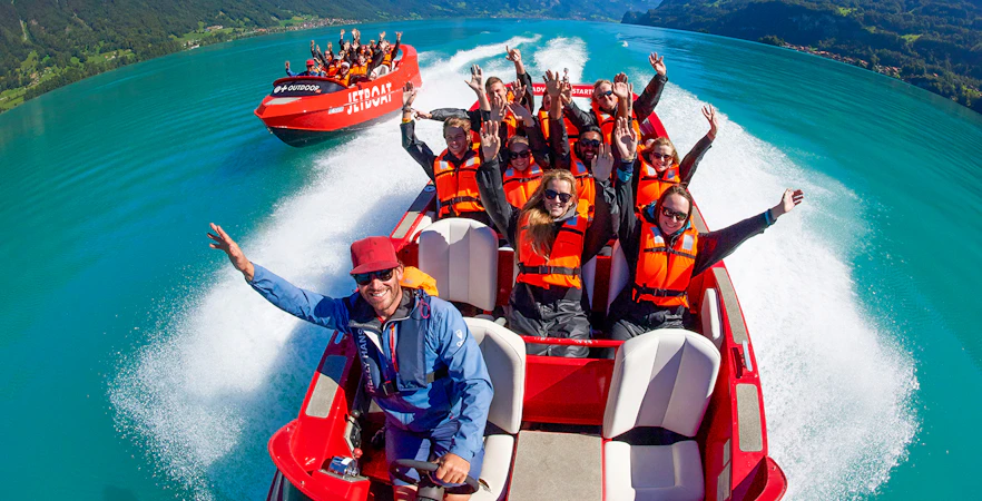 Jetboat ride on Lake Brienz with passengers in life jackets enjoying the scenic view.