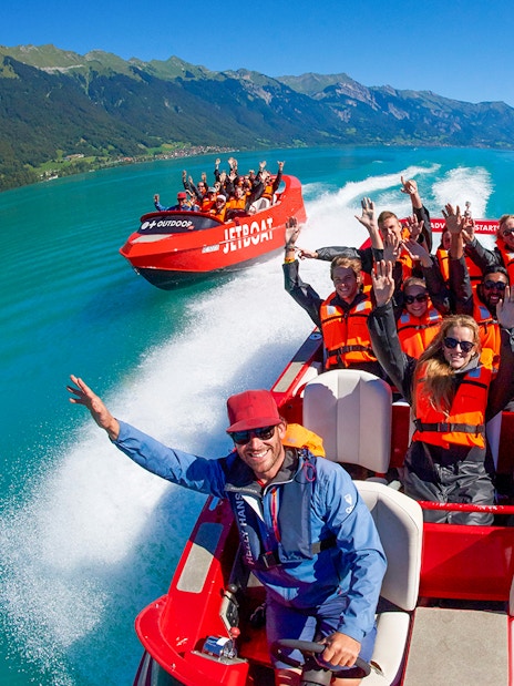 Jetboat ride on Lake Brienz with passengers in life jackets enjoying the scenic view.