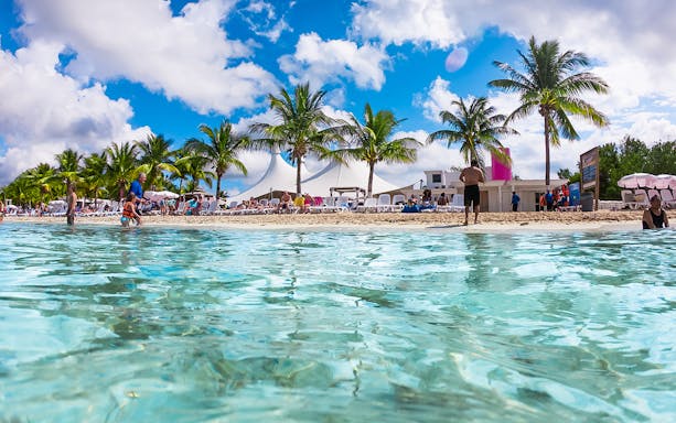 Visitors enjoying the beach at Playa Mia Grand Beach Park, Cozumel.