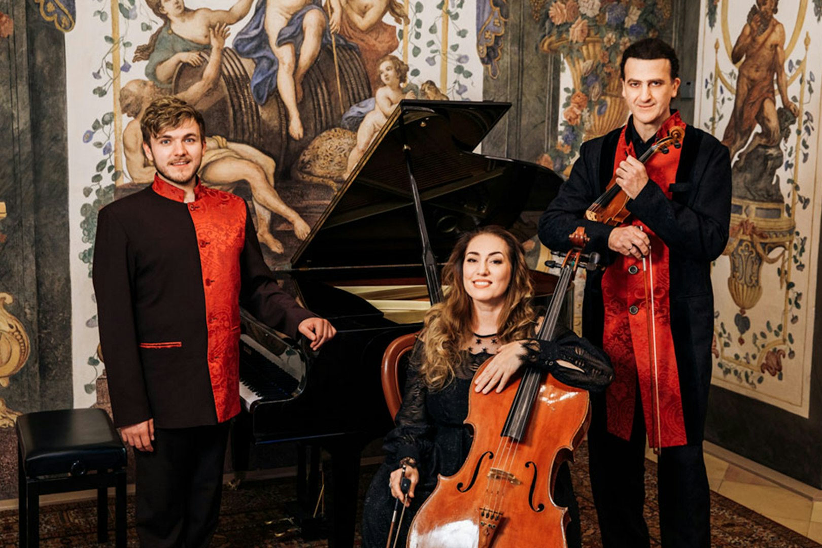 Musicians with piano, cello, and violin at Mozarthouse concert.