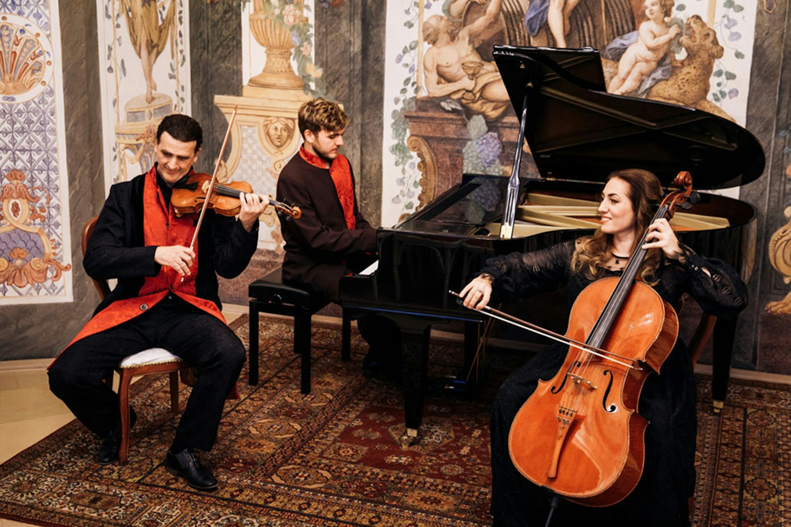 Musicians performing with violin, piano, and cello at Mozarthouse concert.