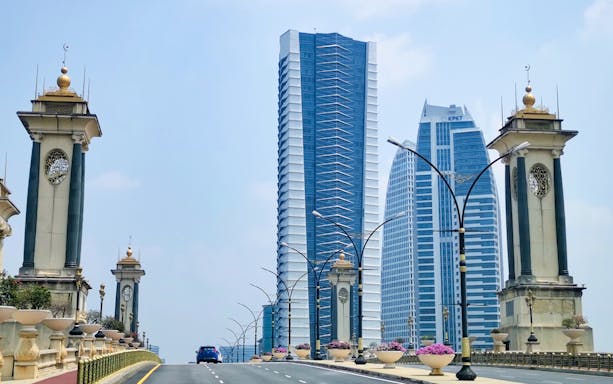 Putrajaya bridge with modern skyscrapers in the background, Malaysia.