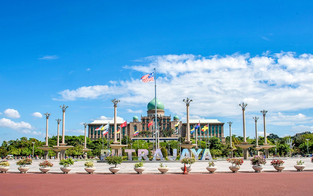Putrajaya government complex with flags and domed building, Malaysia.