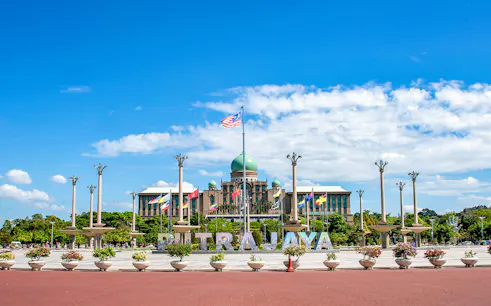 Putrajaya government complex with flags and domed building, Malaysia.