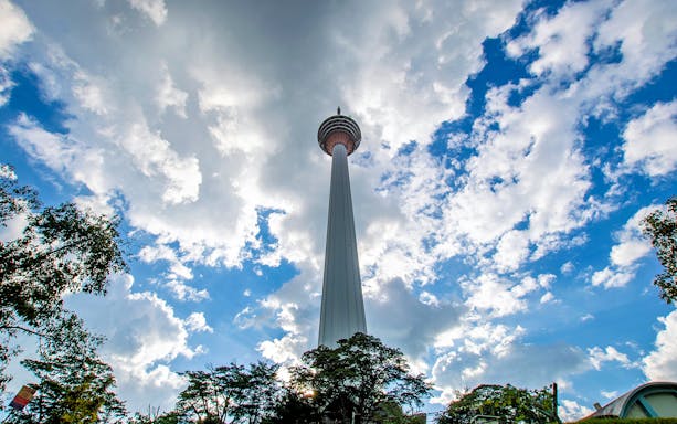 KL Tower against a cloudy sky in Kuala Lumpur, part of the evening tour with Symphony Water Fountain Show.