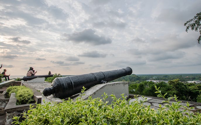 Historic cannon overlooking Kuala Selangor landscape during fireflies night tour.