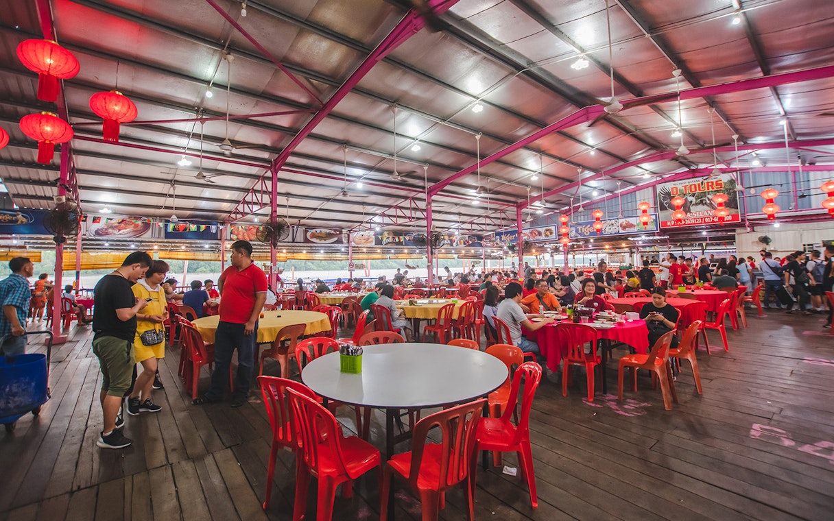 Seafood restaurant in Kuala Selangor with red lanterns and diners enjoying meals.