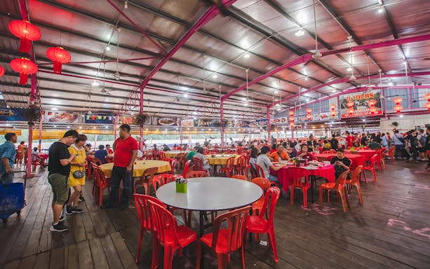 Seafood restaurant in Kuala Selangor with red lanterns and diners enjoying meals.