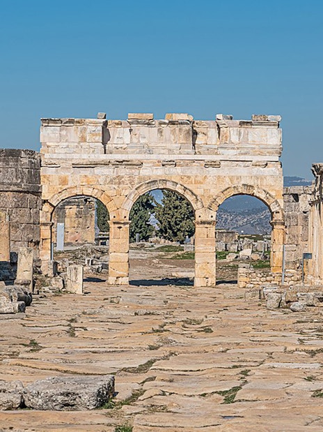 Ancient stone archway and ruins in Hierapolis, Pamukkale, Turkey.