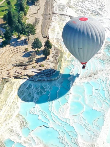 Hot air balloon over Pamukkale's travertine terraces, Turkey, during Antalya/Kemer tour.