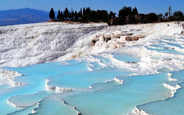 Pamukkale's travertine terraces with turquoise pools in Turkey.
