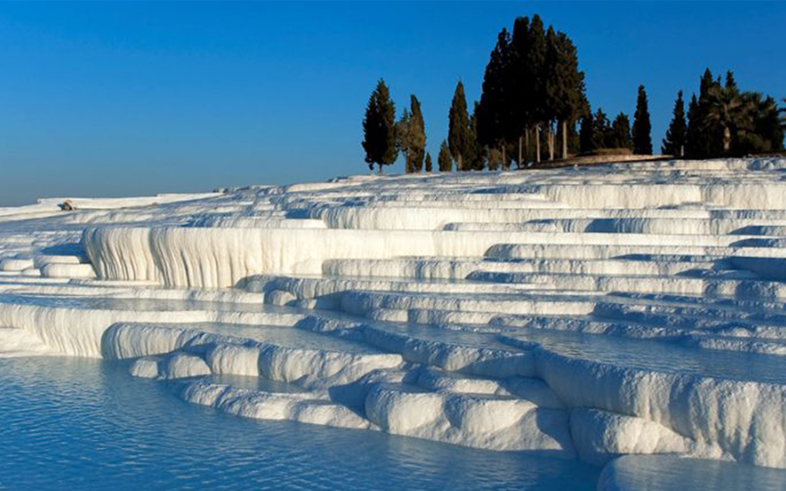 Pamukkale travertine terraces with water pools in Turkey.