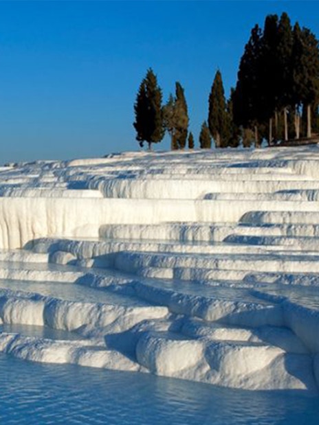 Pamukkale travertine terraces with water pools in Turkey.