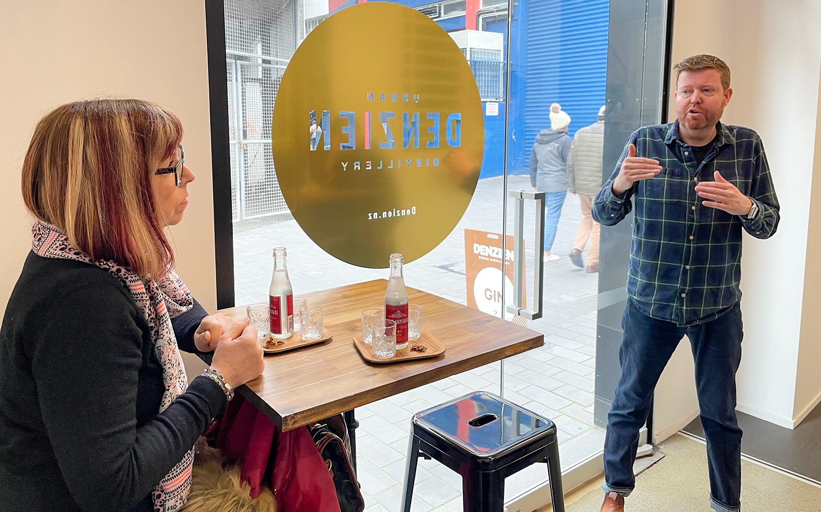 Tour guide explaining at Denizen Distillery during Foodie Delights Private Tour in Wellington.