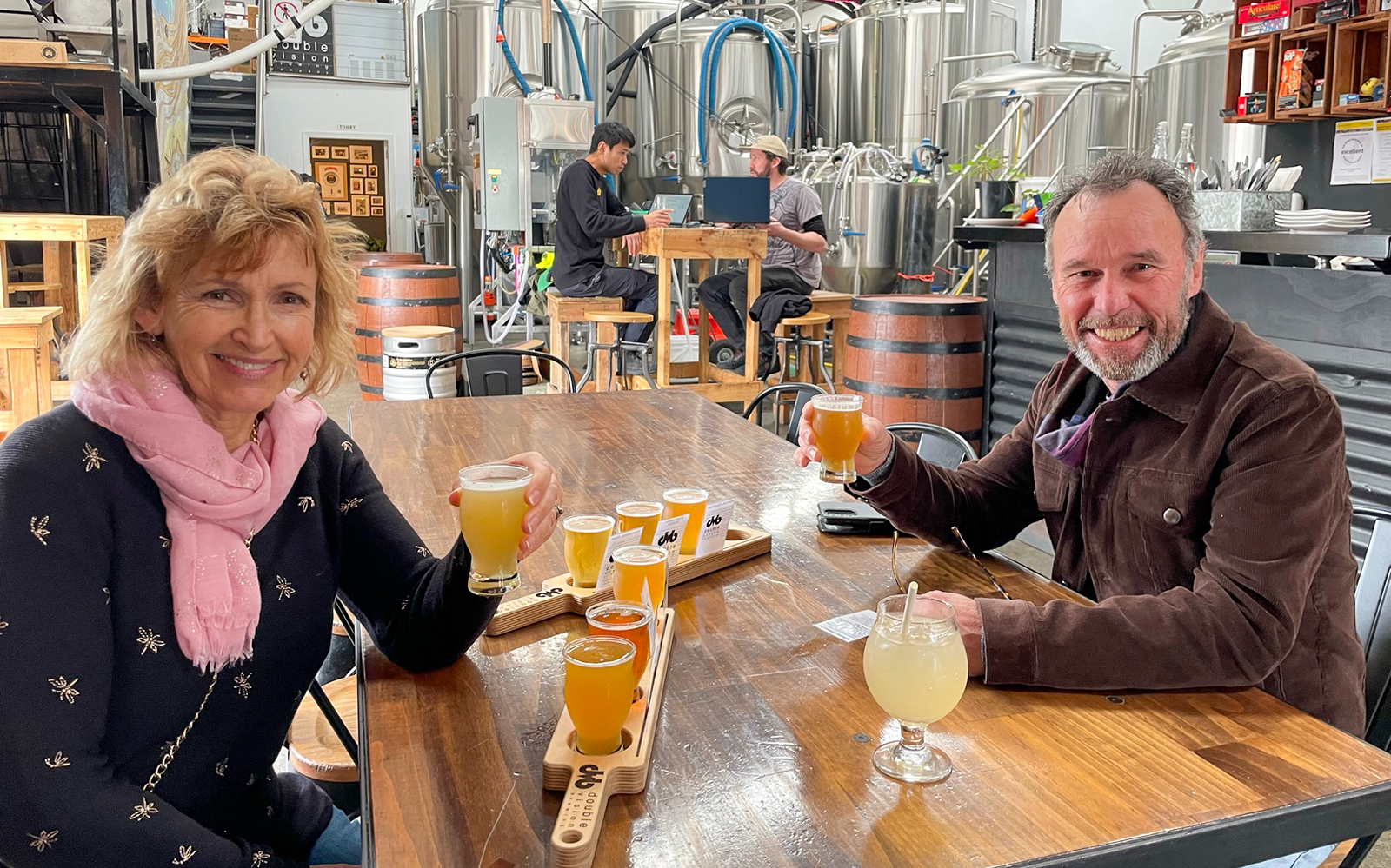 Couple enjoying craft beer tasting at a brewery in Wellington.