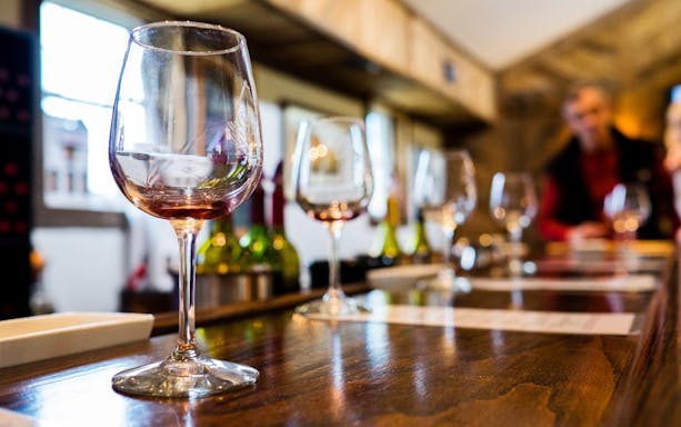 Wine glasses on a wooden table during Martinborough wine tour.