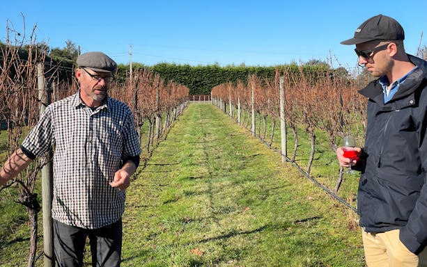 Winemaker discussing vineyard with visitor on A Taste of Martinborough tour.