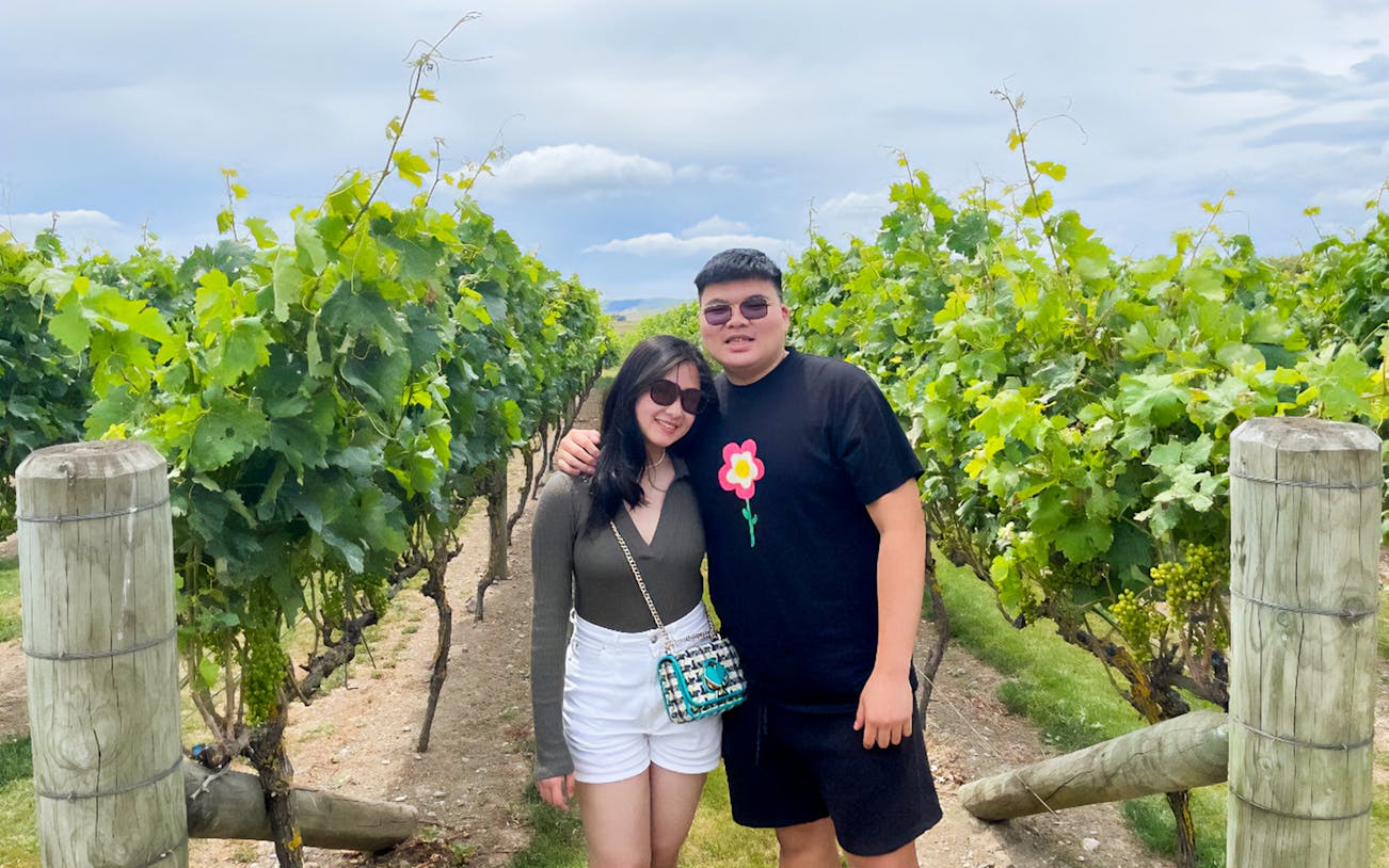 Couple standing in a vineyard during A Taste of Martinborough – Foodie Delights Private Tour.