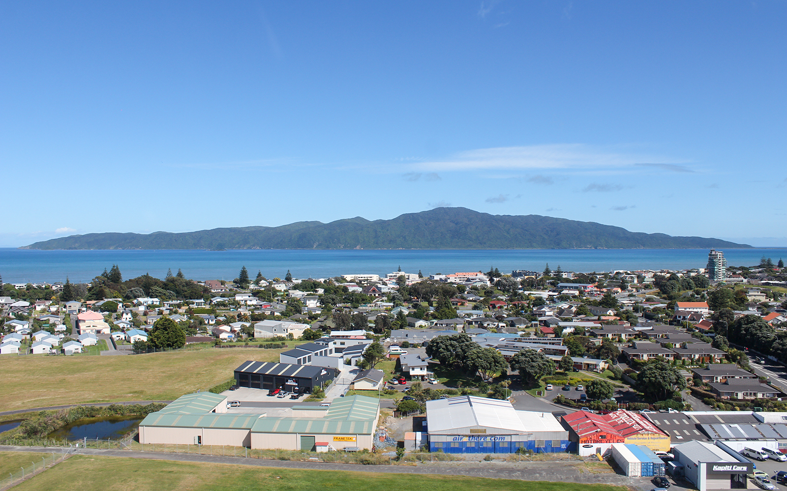 Aerial view of Kāpiti Coast with ocean and island backdrop on a private scenic tour.