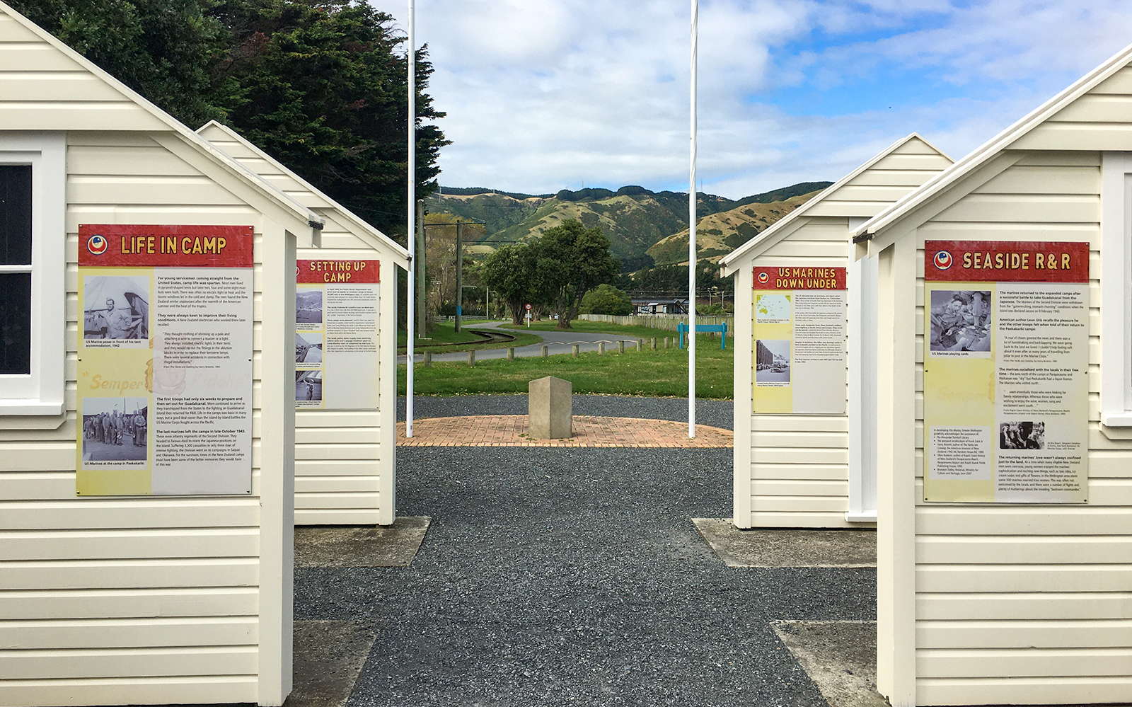 Historic camp buildings with informational panels on Kāpiti Coast tour.