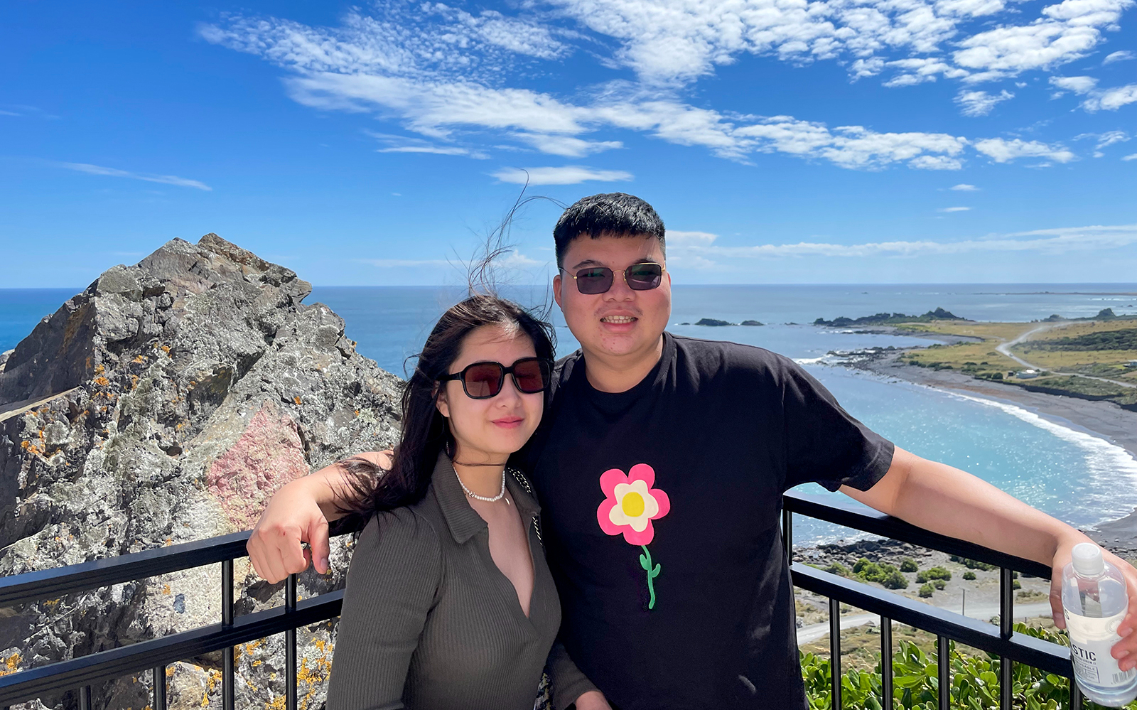 Couple enjoying ocean view from lookout on South Wairarapa tour.