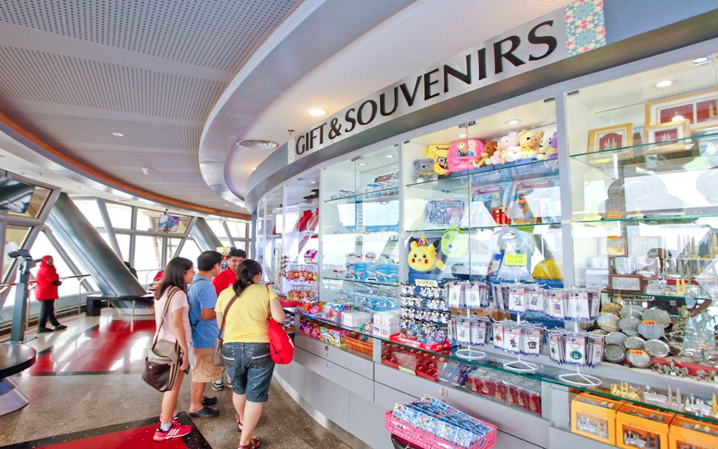 Gift shop at KL Tower Malaysia with visitors browsing souvenirs.