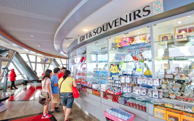 Gift shop at KL Tower Malaysia with visitors browsing souvenirs.