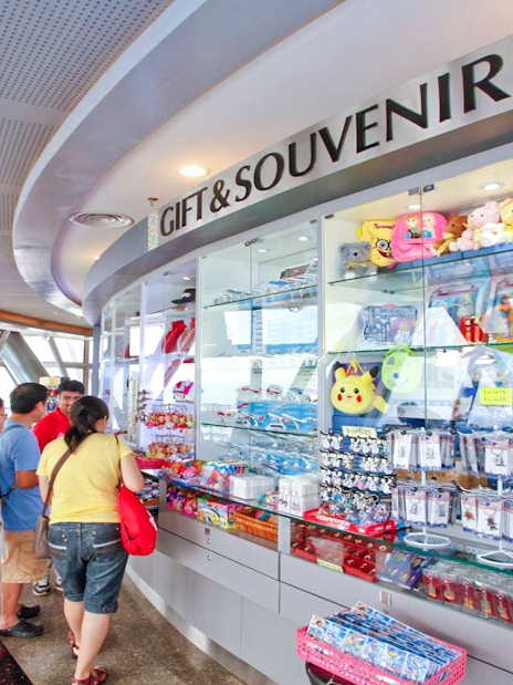 Gift shop at KL Tower Malaysia with visitors browsing souvenirs.