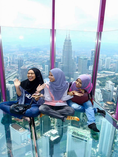 Visitors enjoying the view from the Sky Box at KL Tower, Kuala Lumpur, Malaysia.
