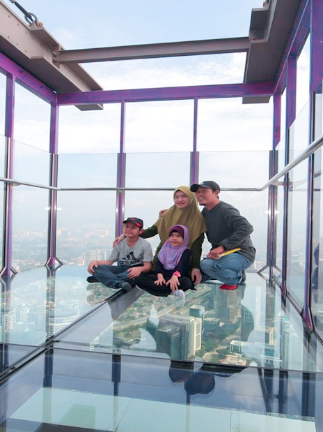 Family enjoying the view from the Sky Box at KL Tower, Malaysia.