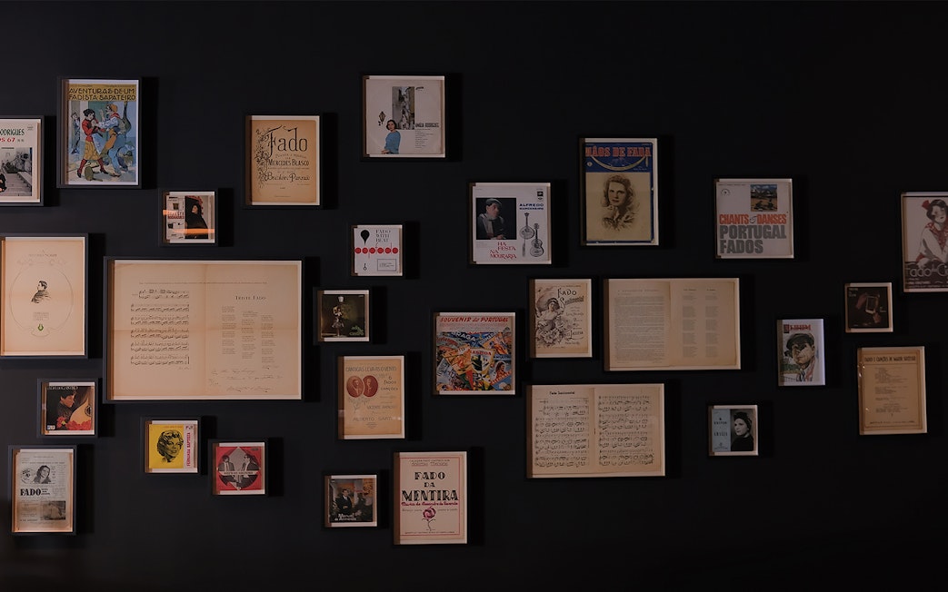 Framed Fado music memorabilia on a wall at Ideal Clube, Portugal.