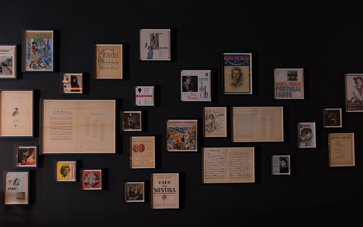 Framed Fado music memorabilia on a wall at Ideal Clube, Portugal.