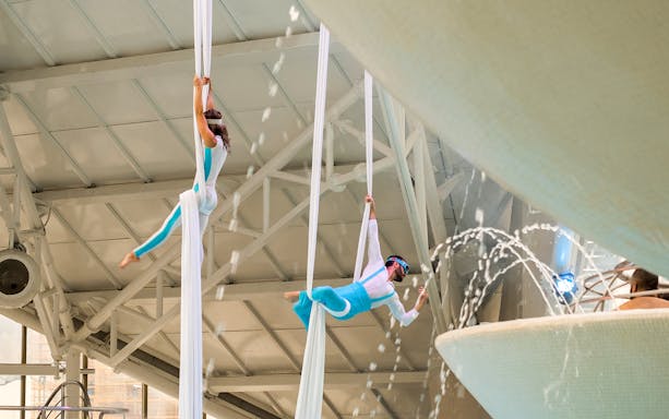 Aerial performers at Thermoludic in Caldea, Andorra, with water features.