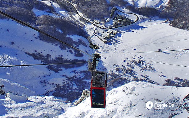 Cable car ascending over snowy landscape at Fuente Dé, Cantabria.