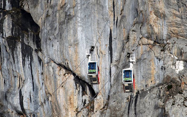 Cable cars ascending rocky cliffs at Fuente Dé, Spain.