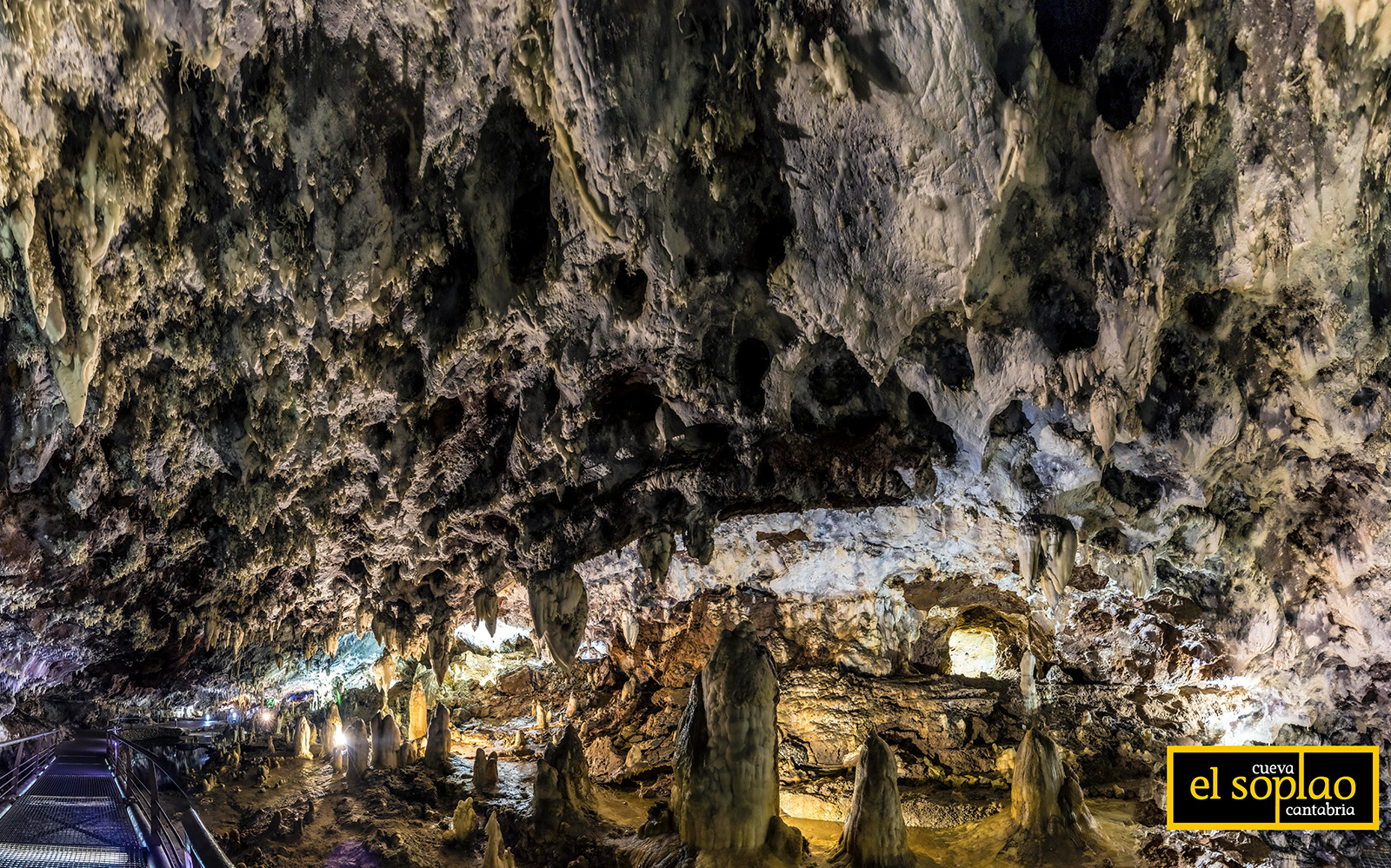 Stalactites and stalagmites inside El Soplao Cave during a guided tour in Cantabria, Spain.