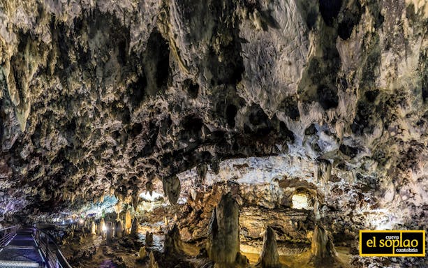 Stalactites and stalagmites inside El Soplao Cave during a guided tour in Cantabria, Spain.