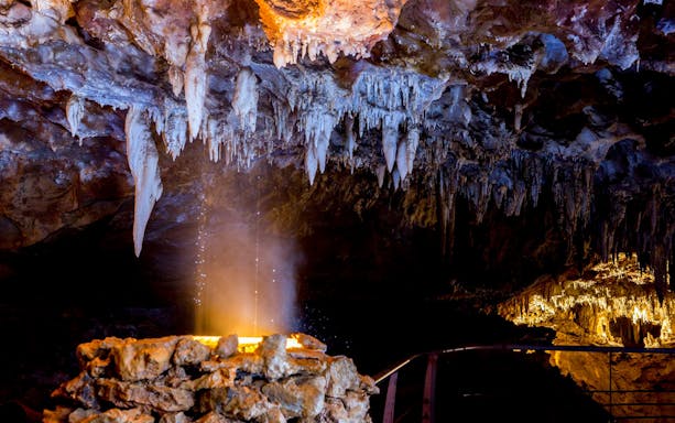 Stalactites and rock formations inside El Soplao Cave during a guided tour.
