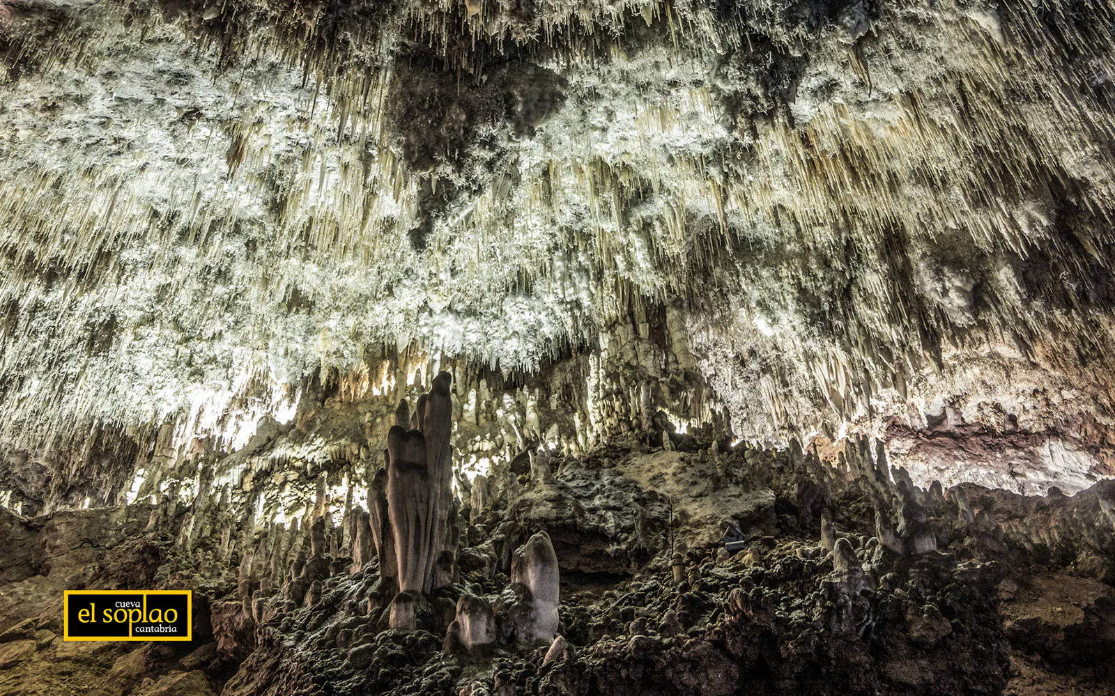 Stalactites and stalagmites inside El Soplao Cave during a guided tour in Cantabria, Spain.