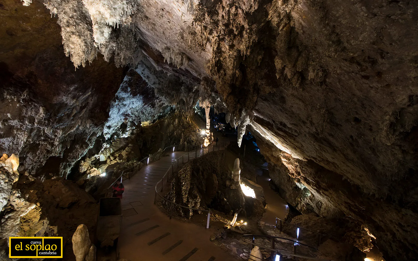 Guided tour path inside El Soplao Cave with stalactites and rock formations.