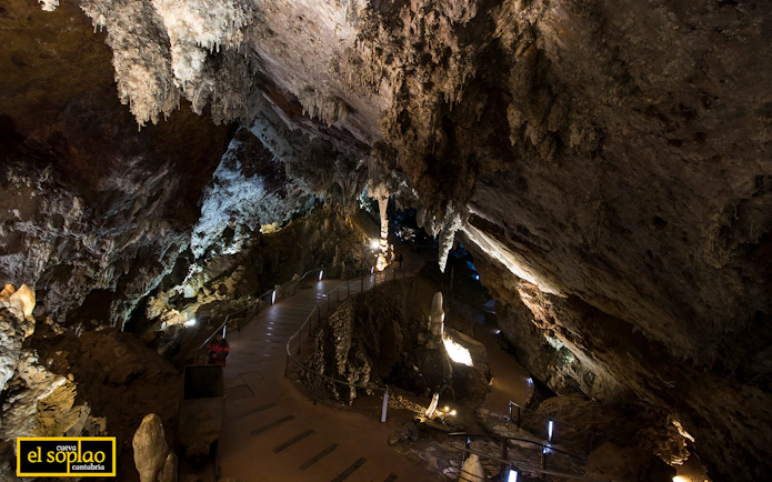 Guided tour path inside El Soplao Cave with stalactites and rock formations.