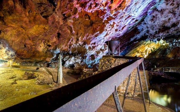 El Soplao Cave interior with colorful rock formations and walkway on guided tour.