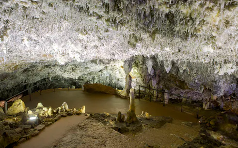 El Soplao Cave stalactites and stalagmites on guided tour path.