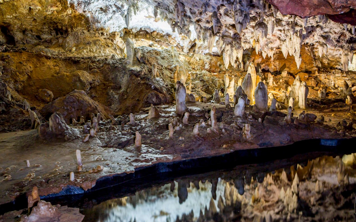 Stalactites and stalagmites in El Soplao Cave during a guided tour.