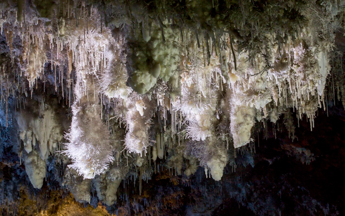 Stalactites in El Soplao Cave during guided tour, Cantabria, Spain.
