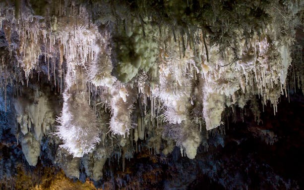 Stalactites in El Soplao Cave during guided tour, Cantabria, Spain.